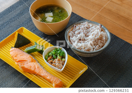 A healthy Japanese breakfast of grilled salmon, natto, and mixed grain rice A healthy Japanese breakfast of grilled salmon, natto, and mixed grain rice 129366231