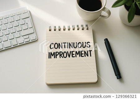 Top view of Continuous Improvement on white notepad representing Practices to Drive Innovation Across All Departments. 129366321