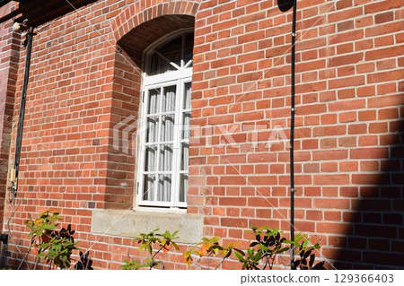 white window frame red brick wall 129366403