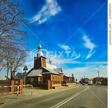 Traditional Wooden Church in Rural Landscape, Rustic Slavic Architecture" 129366504