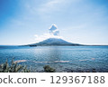 Sakurajima in Kagoshima floating in Kinko Bay on a clear day Sakurajima in Kagoshima floating in Kinko Bay on a clear day 129367188