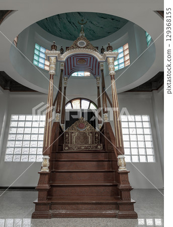 Ornately decorated minbar pulpit from where prayers are led standing on a platform at Safirusslam Mosque. 129368155