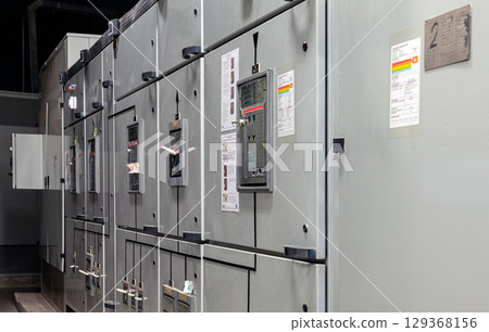 Perspective side view of Control panel system integration inside of Electric voltage control room. Perspective side view of Control panel system integration inside of Electric voltage control room. 129368156