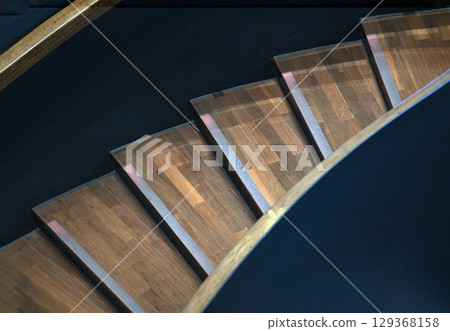 Layered wood spiral stairs with railings handle grip interior. Layered wood spiral stairs with railings handle grip interior. 129368158