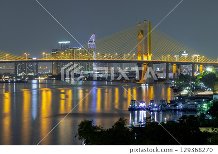 Scenery view after sunset of Thotsamarachan Bridge (Rama IX Bridge) crossing Chao phraya river. Scenery view after sunset of Thotsamarachan Bridge (Rama IX Bridge) crossing Chao phraya river. 129368270