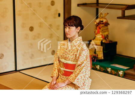 A woman in a kimono quietly standing in a samurai residence 129368297