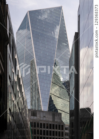 a striking perspective of The Scalpel building, characterized by its sharp, angular, and geometric design, standing as a prominent commercial skyscraper. a striking perspective of The Scalpel building, characterized by its sharp, angular, and geometric design, standing as a prominent commercial skyscraper. 129368373