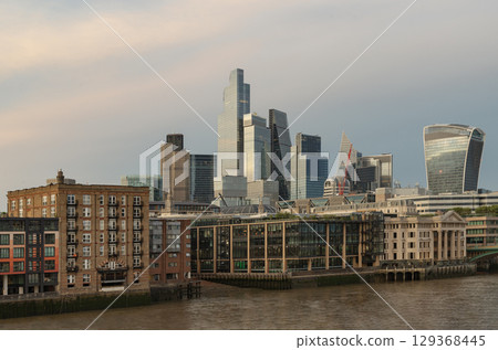 the distinctive London skyline, featuring prominent modern skyscrapers including Walkie-Talkie" building (20 Fenchurch Street), alongside residential and commercial structures in the foreground. 129368445