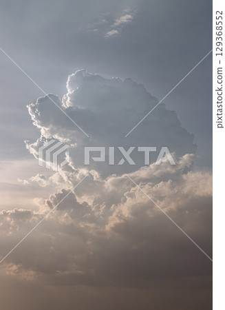 The sky is being covered with fluffy white clouds. Amazing clouds like a heaven for background wallpaper and texture. 129368552