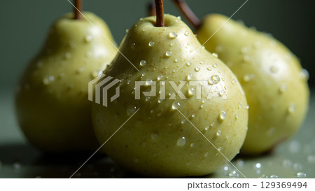 Captivating still life of three fresh green pears adorned with glistening water droplets revealing nature's beauty Captivating still life of three fresh green pears adorned with glistening water droplets revealing nature's beauty 129369494