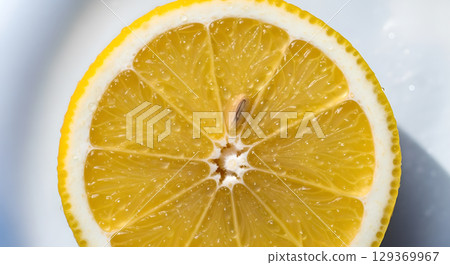 A vibrant close-up of a lemon slice showcasing its juicy segments and refreshing appeal for healthy recipes 129369967