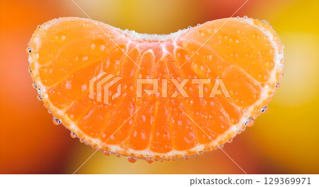 A vibrant close up of a juicy mandarin segment sparkling with fresh water droplets offers refreshment A vibrant close up of a juicy mandarin segment sparkling with fresh water droplets offers refreshment 129369971
