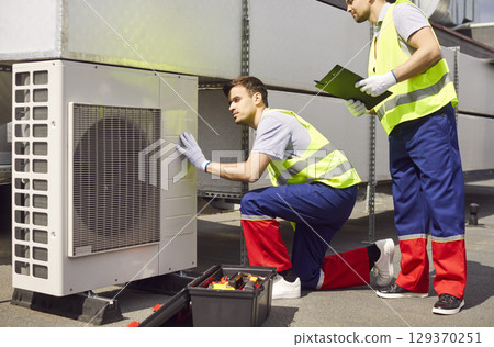 Engineer Colleagues Repairing Or Maintaining Of Hvac Or Ventilation System 129370251