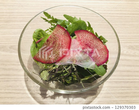 Fresh salad served in a clear bowl Fresh salad served in a clear bowl 129370303