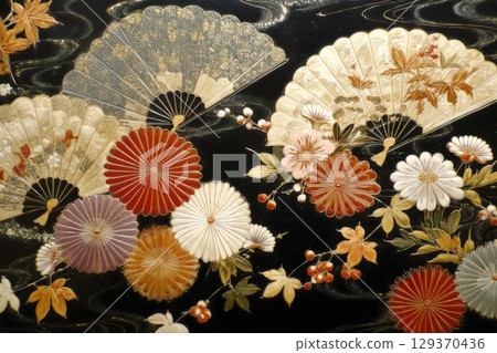 Fan and flowers on a black background 129370436