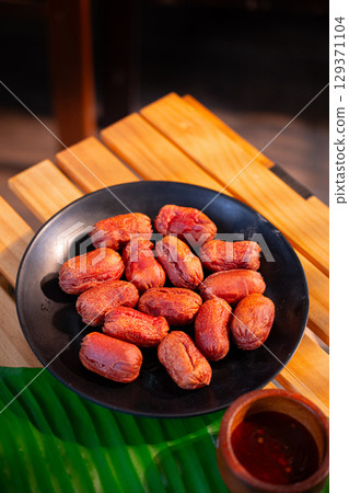 The Fried red sausage on Black Plate for Thai food concept. 129371104