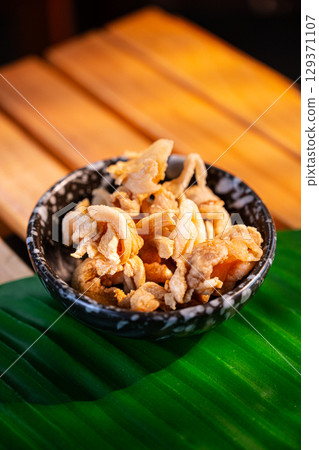 The Fried pork rinds in bowl for food concept. 129371107