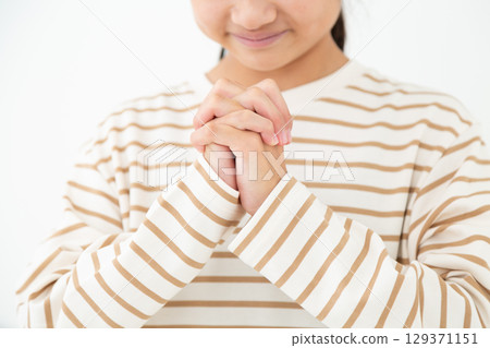 A middle school girl praying and making a wish 129371151