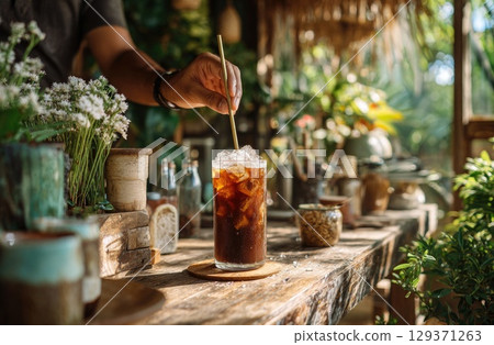 iced coffee being served in front view, with the barista hand. iced coffee being served in front view, with the barista hand. 129371263