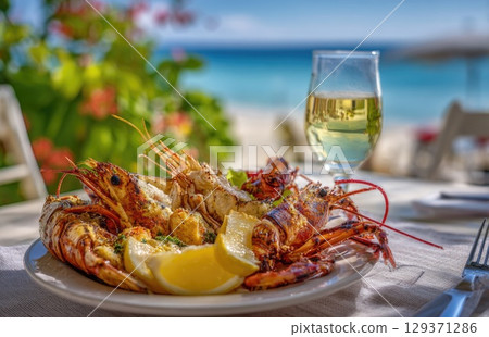 plate of fresh, grilled seafood with prawns and lobster on the beach in sunny Caribbean island 129371286