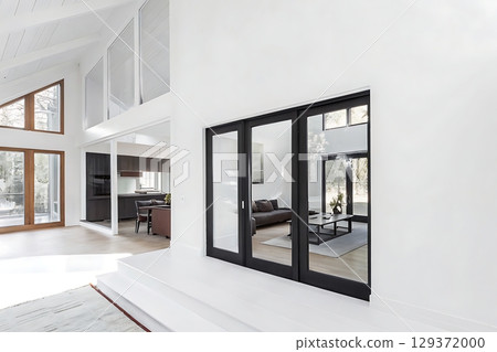 Modern minimalist home interior with large windows and elegant black doors in bright space 129372000