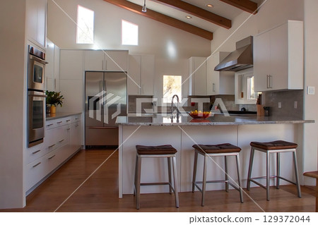 Modern Bright Kitchen with Open Layout and Natural Light Streaming Through Windows Modern Bright Kitchen with Open Layout and Natural Light Streaming Through Windows 129372044