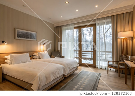 Cozy Hotel Room with Twin Beds and Scenic View of Snowy Landscape through Large Windows Cozy Hotel Room with Twin Beds and Scenic View of Snowy Landscape through Large Windows 129372103