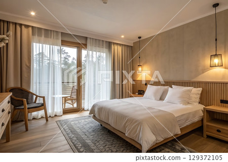 Cozy and Modern Hotel Room with Natural Light and Elegant Decor for Relaxation 129372105