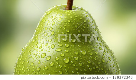 Freshness and health: Close-up of a green pear covered in dewdrops showcasing natural beauty and healthy eating 129372343