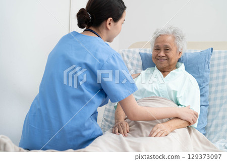 Asian doctor checking and treat elderly woman patient health in hospital. 129373097