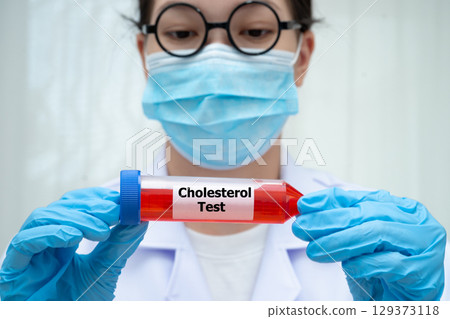 Scientist medical professional holding Cholesterol test tube blood for research in science laboratory. Scientist medical professional holding Cholesterol test tube blood for research in science laboratory. 129373118