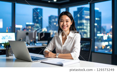 Portrait of a female employee working on a computer 129373249