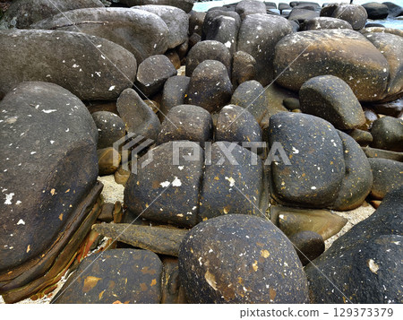 Rugged coastal rocks featuring unique beautifully textures Rugged coastal rocks featuring unique beautifully textures 129373379
