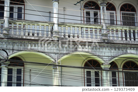 Detailed view of windows, doors and balconies of city buildings  129373409