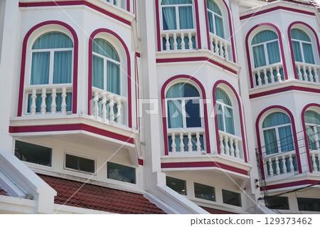 Detailed view of windows, doors and balconies of city buildings  129373462