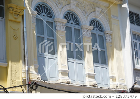 Detailed view of windows, doors and balconies of city buildings  129373479