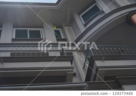 Detailed view of windows, doors and balconies of city buildings  129373488