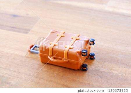 Travel suitcase - Image of preparing a suitcase and setting off on a trip Travel suitcase - Image of preparing a suitcase and setting off on a trip 129373553