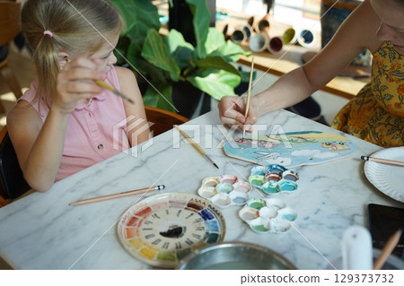 A young mother and her daughter enjoy a creative art session at home A young mother and her daughter enjoy a creative art session at home 129373732