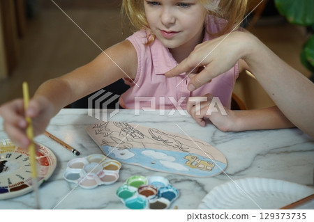 A young mother and her daughter enjoy a creative art session at home  129373735
