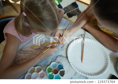 A young mother and her daughter enjoy a creative art session at home A young mother and her daughter enjoy a creative art session at home 129373764
