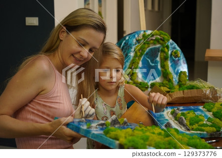 A mother and her daughter craft vibrant natural landscapes A mother and her daughter craft vibrant natural landscapes 129373776