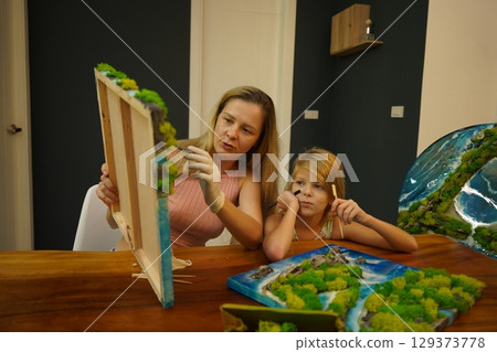 A mother and her daughter craft vibrant natural landscapes A mother and her daughter craft vibrant natural landscapes 129373778