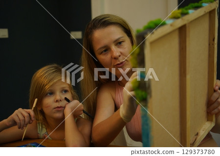 A mother and her daughter craft vibrant natural landscapes A mother and her daughter craft vibrant natural landscapes 129373780