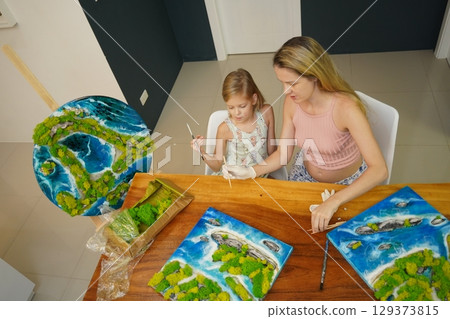 A mother and her daughter craft vibrant natural landscapes A mother and her daughter craft vibrant natural landscapes 129373815