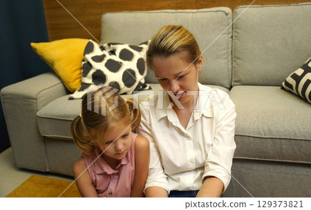 A mother supports her daughter with homework A mother supports her daughter with homework 129373821