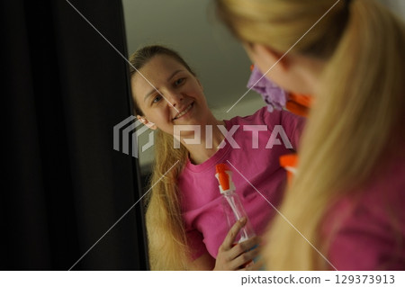 A woman is cleaning her living room at home 129373913