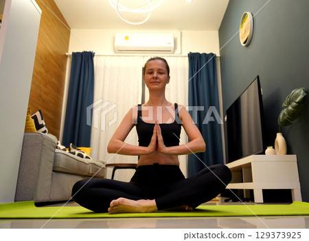 A young woman have a joyfully yoga practice  A young woman have a joyfully yoga practice  129373925