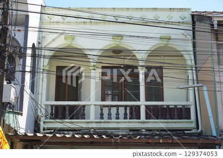 Detailed view of windows, doors and balconies of city buildings  129374053