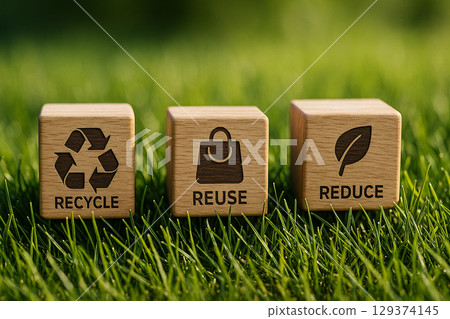 Wooden Blocks with Recycling Symbols on Vibrant Outdoor Grass Surface. Recycle, Reuse and Reduce concept Wooden Blocks with Recycling Symbols on Vibrant Outdoor Grass Surface. Recycle, Reuse and Reduce concept 129374145